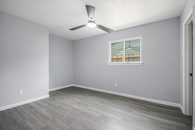 unfurnished bedroom with wood finished floors, ceiling fan, and baseboards