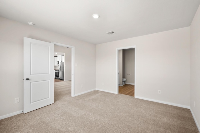 unfurnished room with light carpet, baseboards, and visible vents