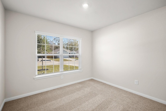 spare room with baseboards, carpet, and recessed lighting