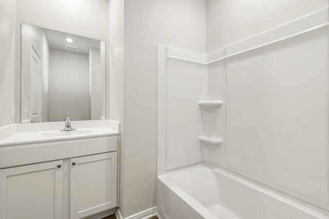 bathroom with washtub / shower combination, vanity, and visible vents