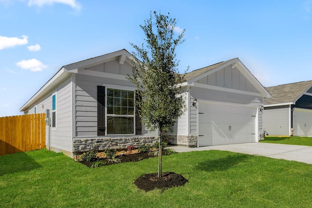 ranch-style home featuring board and batten siding, a front yard, fence, an attached garage, and driveway