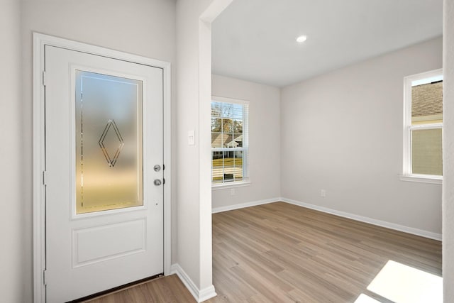 doorway with recessed lighting, light wood-type flooring, and baseboards