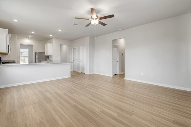 unfurnished living room featuring visible vents, baseboards, ceiling fan, recessed lighting, and light wood-style flooring