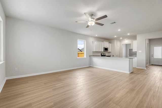 unfurnished living room featuring visible vents, ceiling fan, light wood-style floors, and baseboards