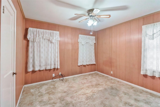 1220 San Felipe St, Angleton, TX 77515 - empty room featuring carpet, a ceiling fan, and wooden walls