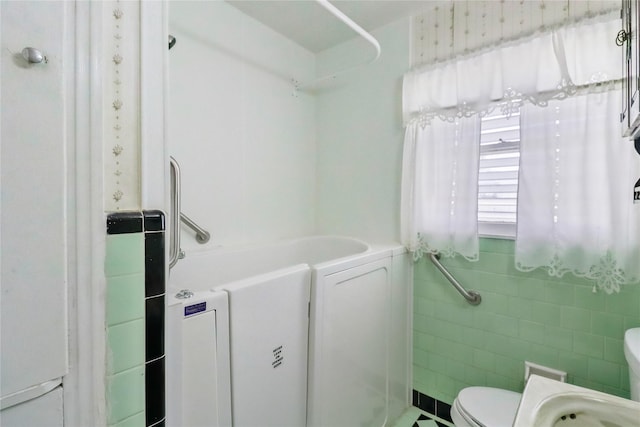 1220 San Felipe St, Angleton, TX 77515 - full bathroom with tile walls and toilet