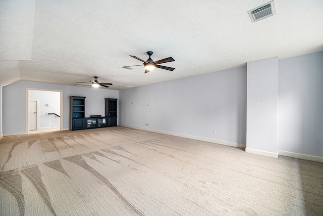 2117 Quiet Falls Ln, League City, TX 77573 - unfurnished living room with baseboards, a textured ceiling, visible vents, ceiling fan, and light colored carpet