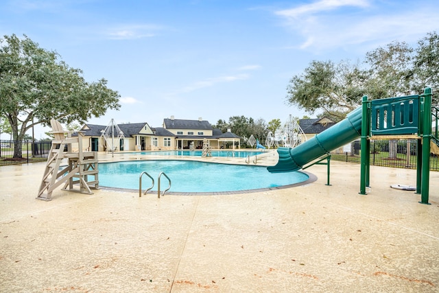 2117 Quiet Falls Ln, League City, TX 77573 - community pool featuring a patio area, playground community, fence, and a water slide