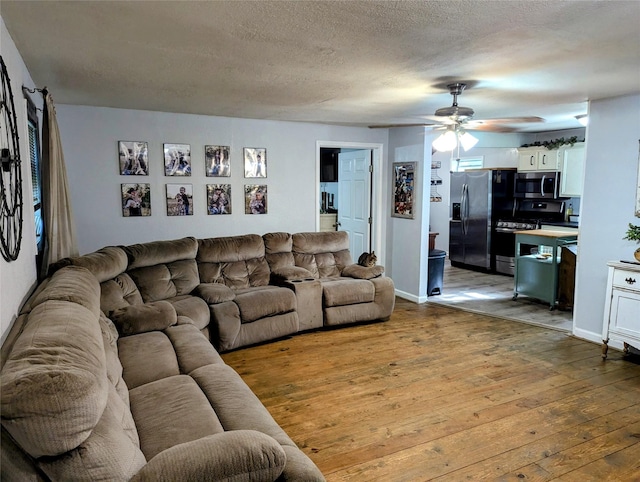 200 Commanche Rd, Conroe, TX 77316 - living area featuring a textured ceiling, ceiling fan, wood-type flooring, and baseboards