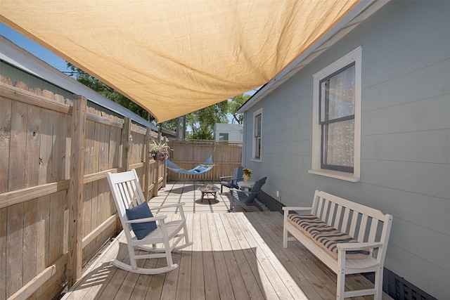deck featuring fence and an outdoor hangout area