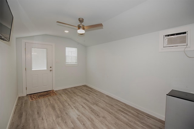 foyer with light wood finished floors, lofted ceiling, baseboards, and ceiling fan