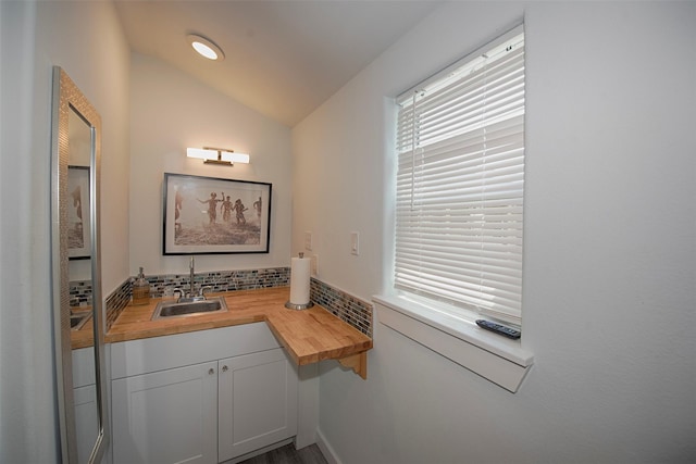bathroom with lofted ceiling and a sink