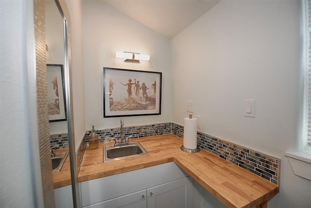 workout area featuring a sink and lofted ceiling