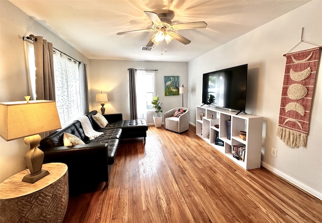 living room with baseboards, ceiling fan, wood finished floors, and visible vents