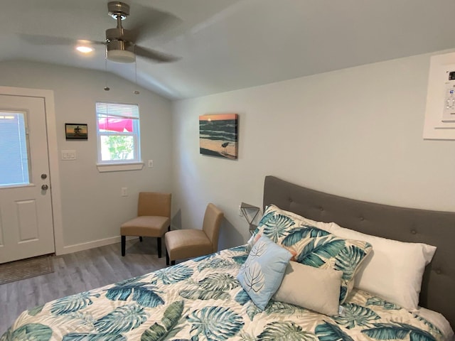 bedroom featuring vaulted ceiling, baseboards, a ceiling fan, and wood finished floors