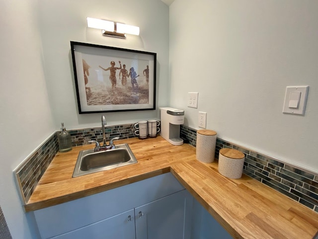 bathroom featuring decorative backsplash and a sink