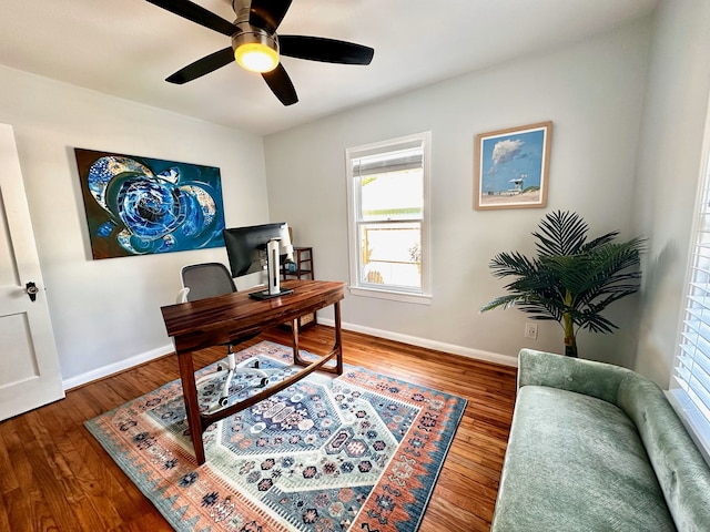 home office featuring baseboards, a wealth of natural light, ceiling fan, and wood finished floors