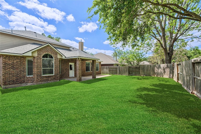 view of yard featuring a patio area and a fenced backyard