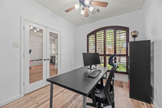 office featuring light wood-style flooring, ceiling fan, baseboards, visible vents, and french doors