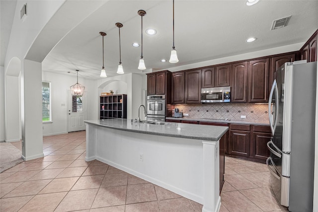 kitchen with recessed lighting, visible vents, backsplash, arched walkways, and appliances with stainless steel finishes