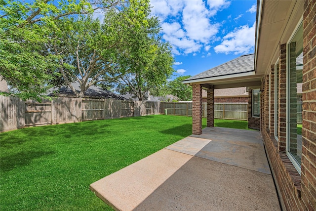 view of yard featuring a patio area and a fenced backyard