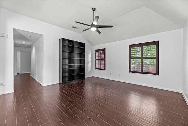 interior space with wood finished floors, vaulted ceiling, ceiling fan, baseboards, and visible vents
