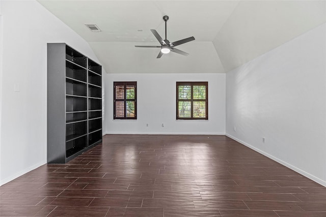 empty room featuring lofted ceiling, ceiling fan, visible vents, wood finished floors, and built in features