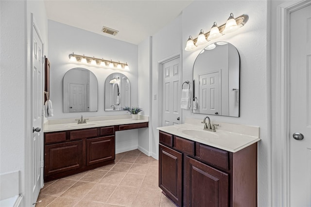 full bathroom featuring tile patterned floors, visible vents, two vanities, and a sink