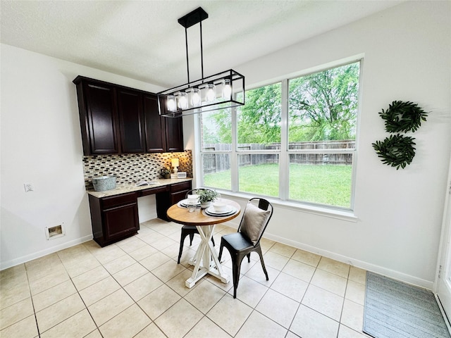 dining space with light tile patterned floors and baseboards