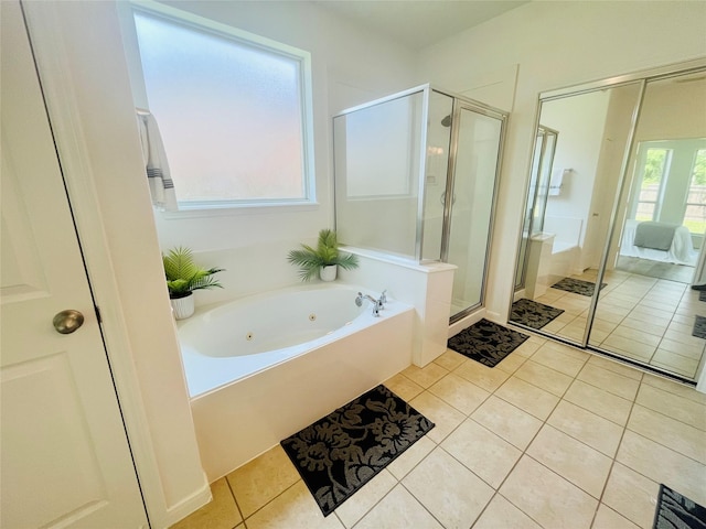 full bath featuring a whirlpool tub, tile patterned flooring, and a stall shower