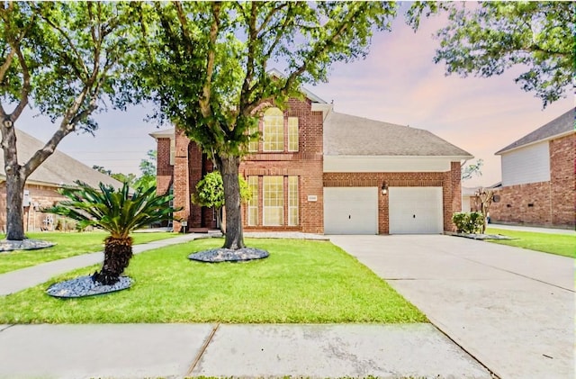 traditional home featuring a garage, a front yard, brick siding, and concrete driveway
