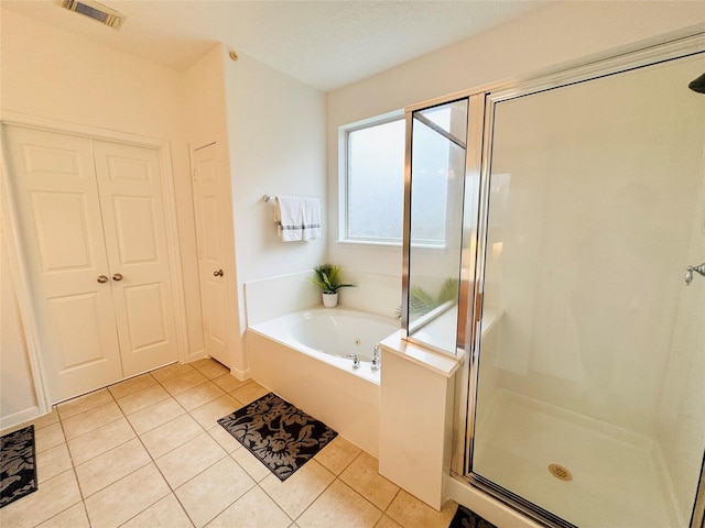 full bath with a shower stall, tile patterned floors, a bath, and visible vents
