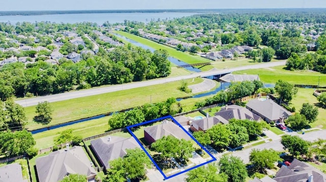 drone / aerial view with a residential view and a water view
