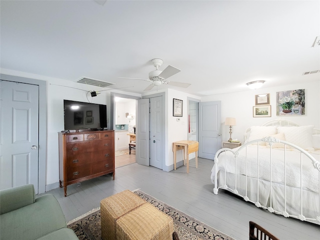 bedroom featuring light wood finished floors, baseboards, and visible vents