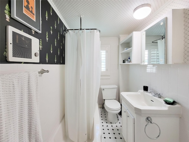 bathroom featuring toilet, shower / tub combo, vanity, and tile walls