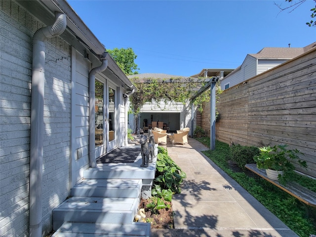 exterior space with a patio area, a fenced backyard, and an outdoor hangout area