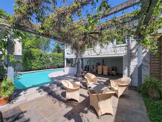 view of swimming pool featuring a patio, outdoor dining space, a fenced in pool, and fence