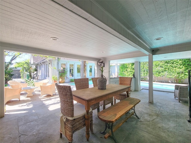view of patio / terrace featuring outdoor dining space, a fenced in pool, and fence
