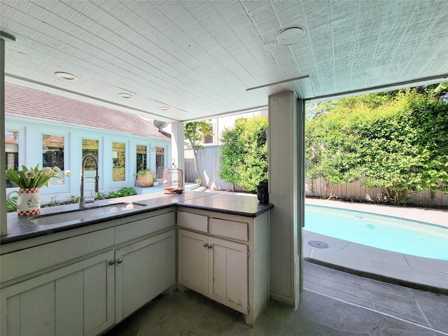 exterior space with fence and a sink