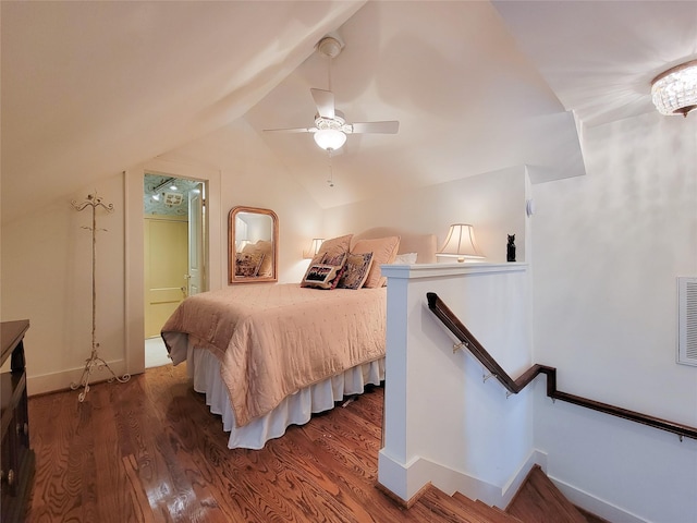 bedroom with baseboards, vaulted ceiling, a ceiling fan, and wood finished floors