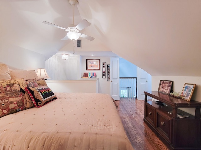 bedroom with visible vents, a ceiling fan, wood finished floors, and lofted ceiling