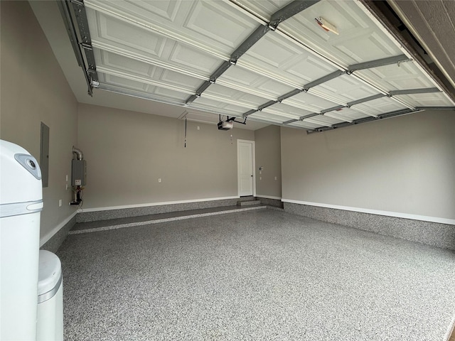garage with baseboards and a garage door opener