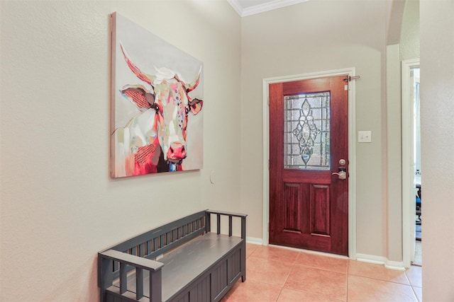 entryway with ornamental molding, baseboards, and light tile patterned flooring