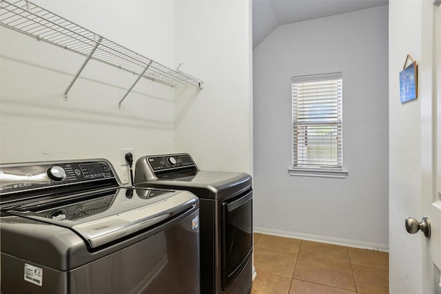 washroom featuring independent washer and dryer, laundry area, baseboards, and tile patterned flooring