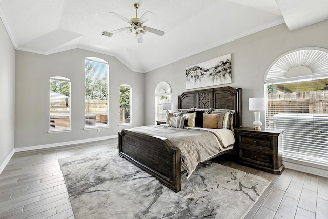 bedroom featuring wood finished floors, vaulted ceiling, ceiling fan, baseboards, and crown molding