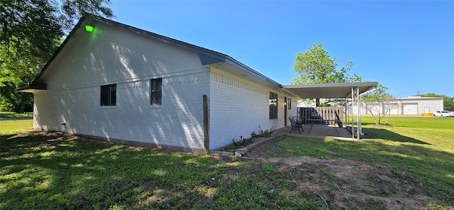 520 Walnut St, Waller, TX 77484 - view of property exterior with a yard, brick siding, and a patio area