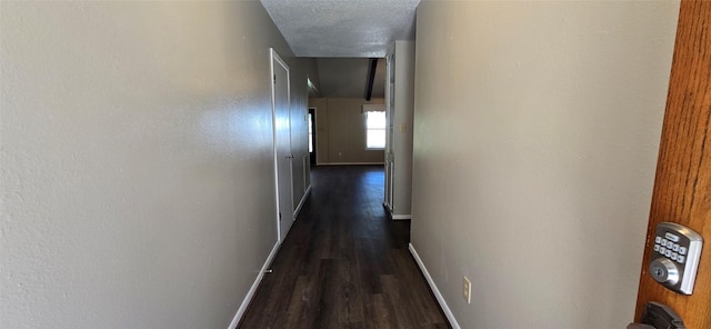 520 Walnut St, Waller, TX 77484 - hall with dark wood-style flooring, baseboards, and a textured ceiling