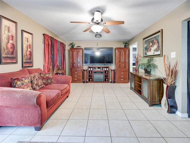 living room with light tile patterned floors, a textured ceiling, and ceiling fan