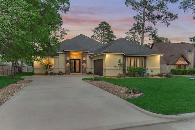 12122 Hawthorne Dr, Montgomery, TX 77356 - view of front of property with stucco siding, driveway, an attached garage, stone siding, and french doors
