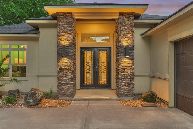 12122 Hawthorne Dr, Montgomery, TX 77356 - view of exterior entry with stone siding, stucco siding, and a shingled roof